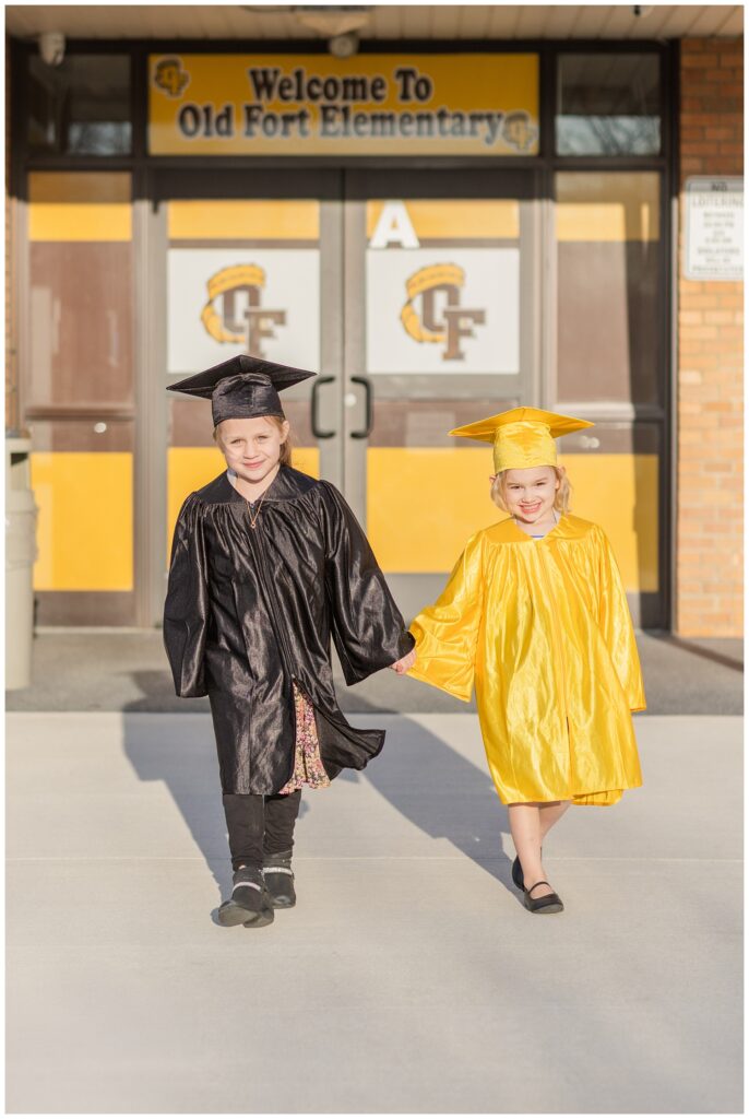 two kindergarten students walking together in front of Old Fort Elementary in Ohio