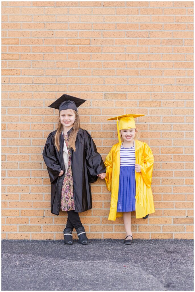 two kindergarteners standing together in front of a brick wall in Tiffin, Ohio