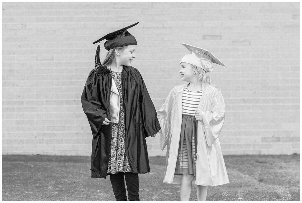 girls walking together holding hands in front of a brick wall in Fremont, Ohio