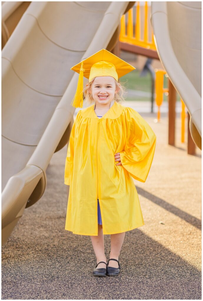 girl posing on the playground for graduation cap and mini session