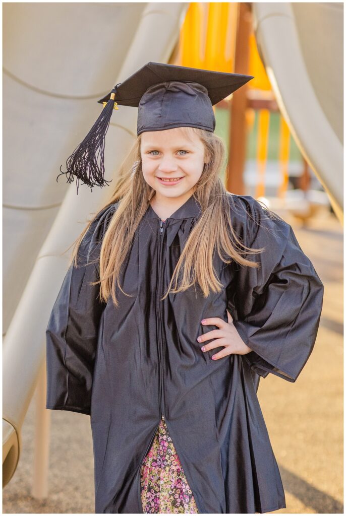 girl posing on the playground for graduation cap and mini session in Tiffin, Ohio