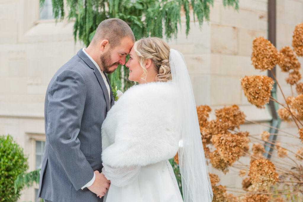 bride and groom posing together at first look with Fremont, Ohio wedding photographer