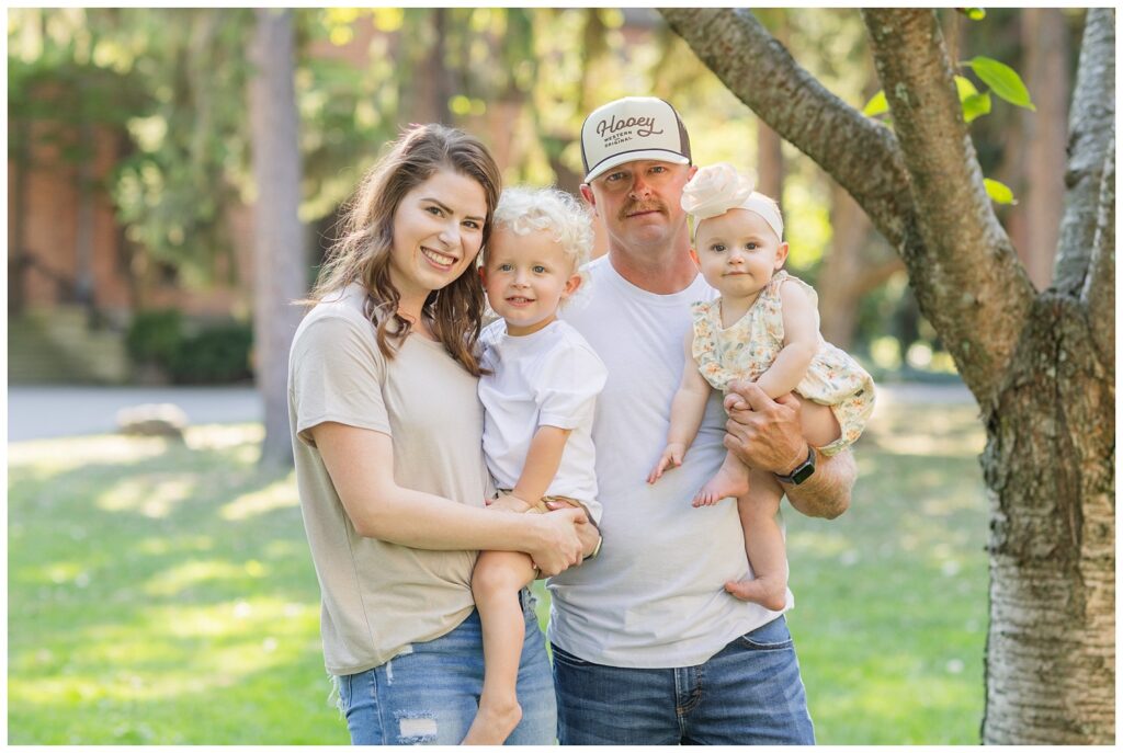 past wedding couple holding their two kids at a family session in Green Springs, Ohio
