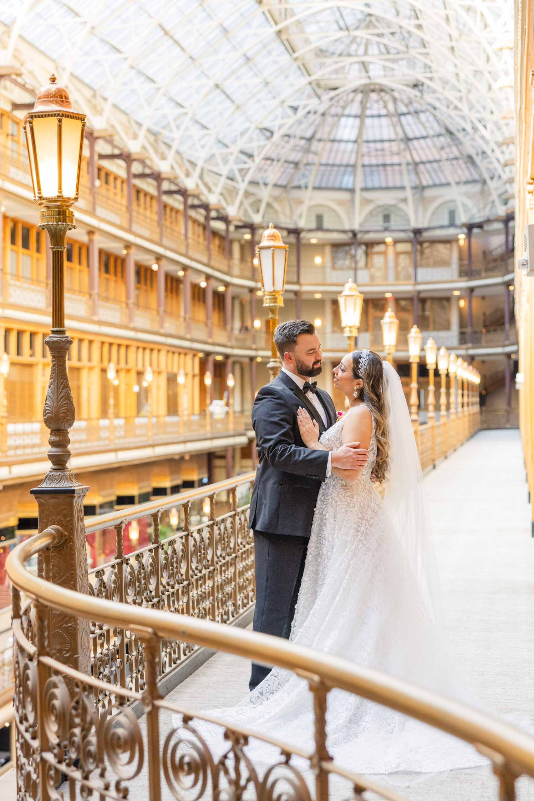 bride and groom posing on the balcony at The Arcade in Cleveland, Ohio