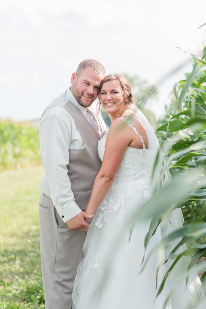 wedding couple posing next to a corn field in Tiffin, Ohio
