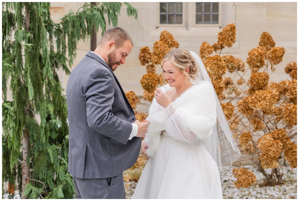 bride and groom posing to create a magical first look for wedding in Fremont, Ohio