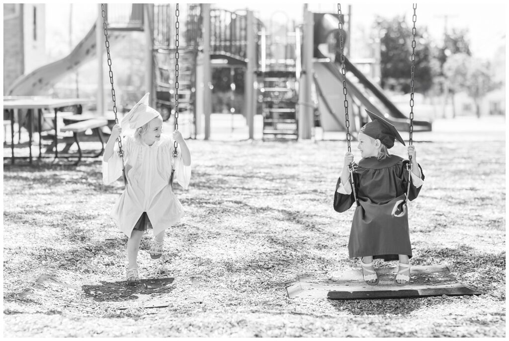 preschool graduates swinging on a playground at mini session in Port Clinton, Ohio