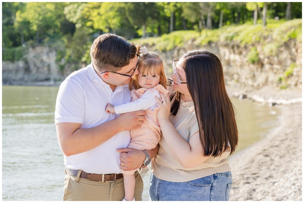 couple smiling and looking at their daughter on the beach at South Bass Island
