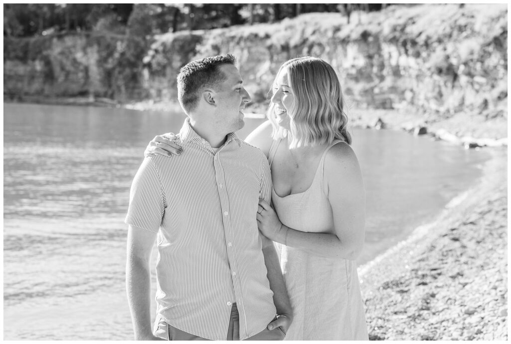 couple smiling together while standing on the stone beach on South Bass Island