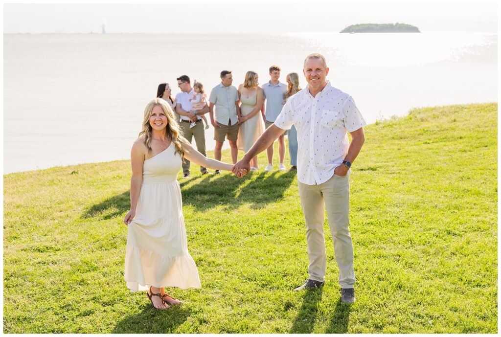 family posing on the grass next to Lake Erie in Put In Bay, Ohio