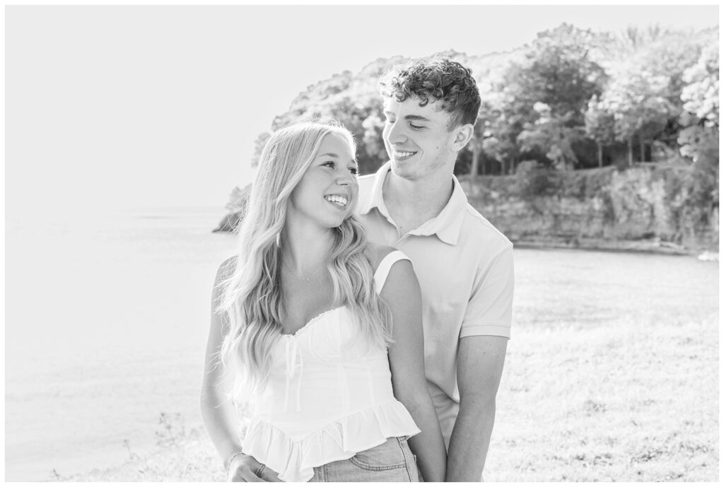 couple smiling at the shore of Lake Erie for summer family session