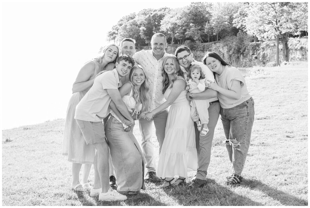 entire extended family hugging on the shore of Lake Erie on South Bass Island