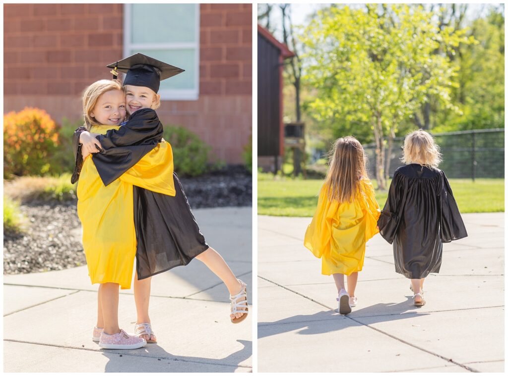 two friends wearing black and yellow graduation gowns and holding hands 