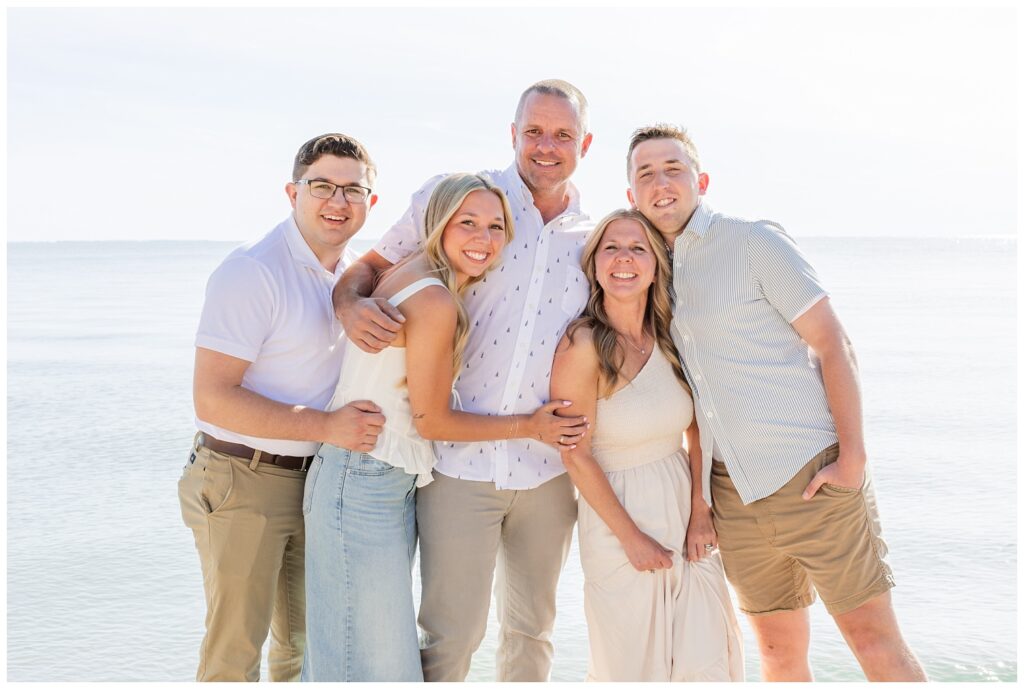 family hugging together on the stone beach on South Bass Island