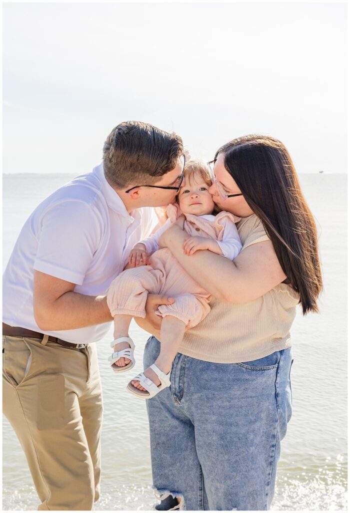 family hugging their daughter at Lake Erie portrait session