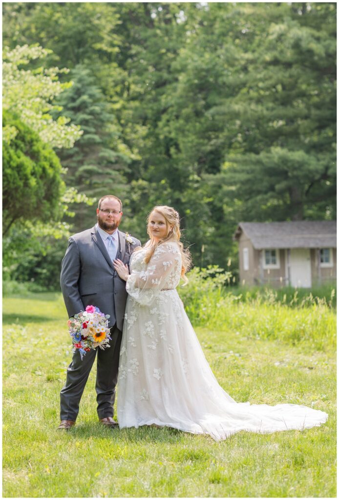 bride and groom posing together near the pond at Bradner Preserve in Ohio