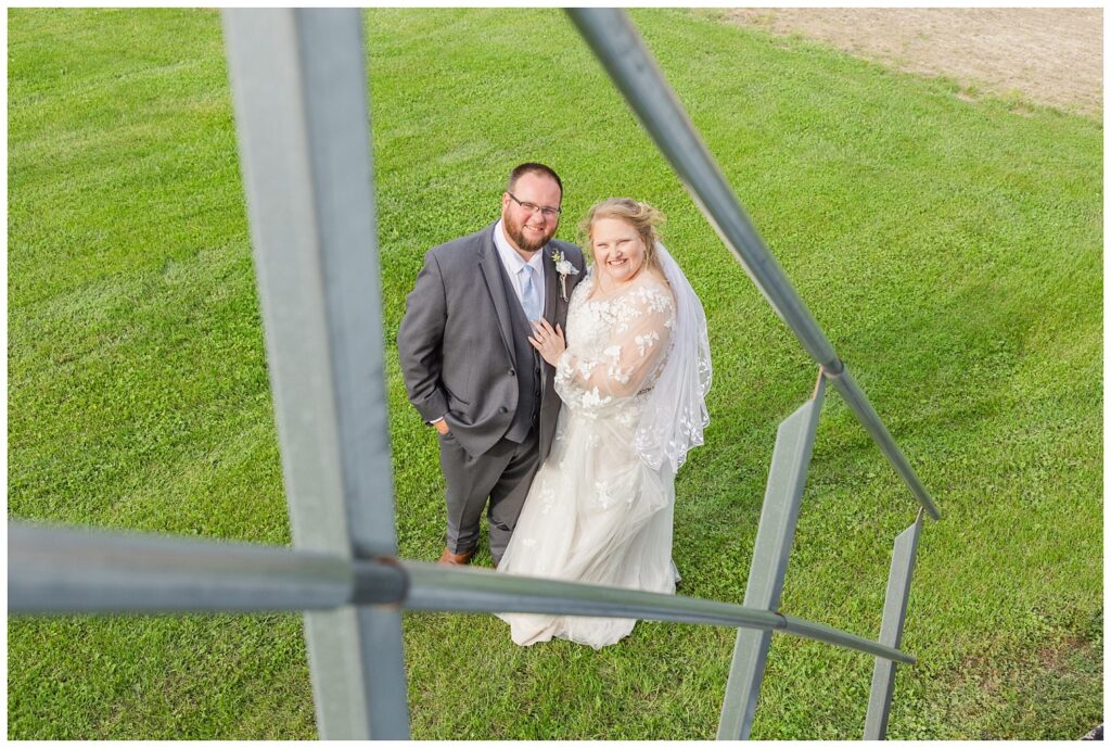 wedding couple posing at the bottom of the grain bin stairs in Risingsun, Ohio