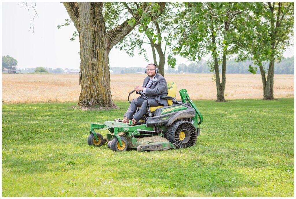 groom riding his green and yellow lawn mower at his home in Risingsun, Ohio