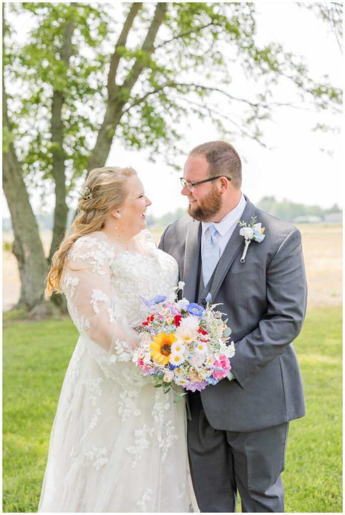 couple posing for portraits for summer wedding in Fostoria, Ohio