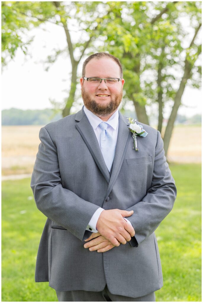 groom crossing his arms and posing in his backyard in Risingsun, Ohio