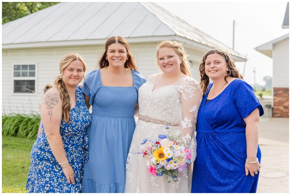 bride posing with her friends at family farm wedding in Risingsun, Ohio