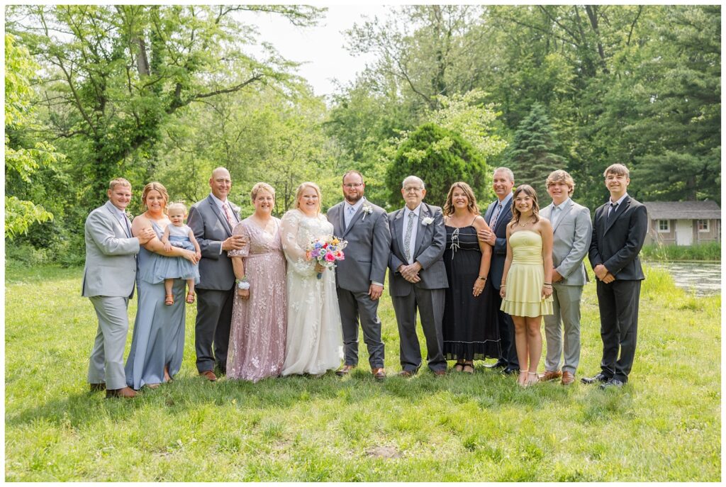 bride and groom posing with groom's family at Bradner Preserve