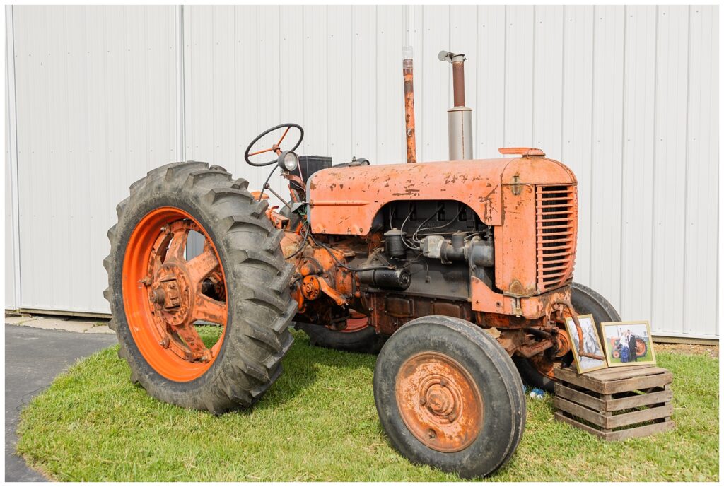 old red tractor displayed in front of a white barn in Fostoria, Ohio for wedding