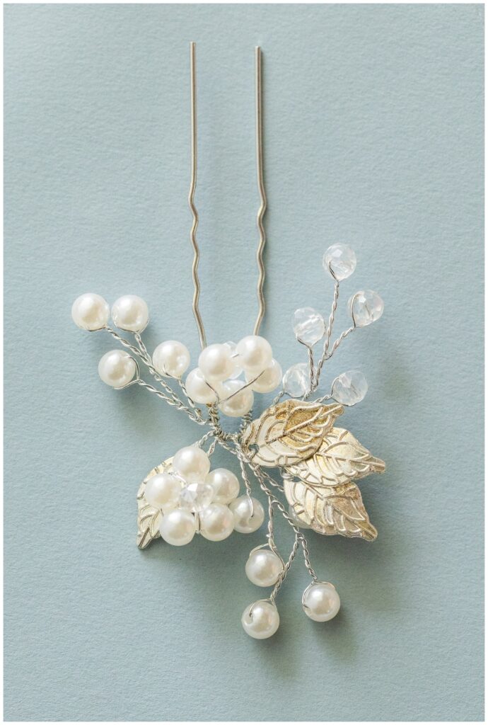 bride's pear and silver lead hair pin sitting on blue mat
