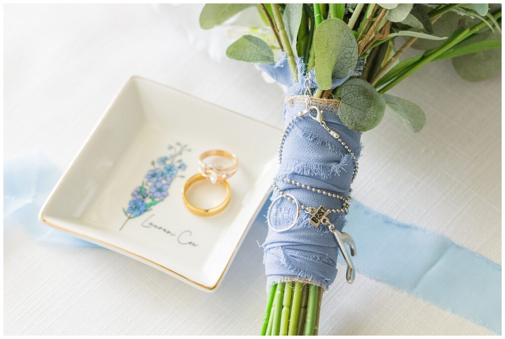 bride's bouquet wrapped in blue fabric with necklace