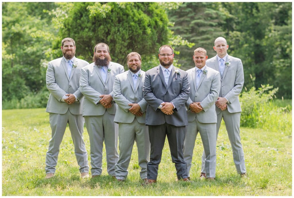 groomsmen posing together for wedding portraits at Bradner Preserve in Ohio