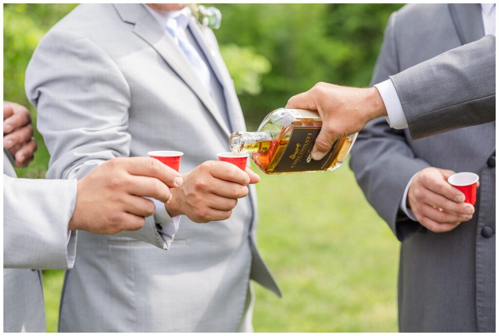 groom and groomsmen drinking shots of Fireball at Bradner Preserve in Ohio