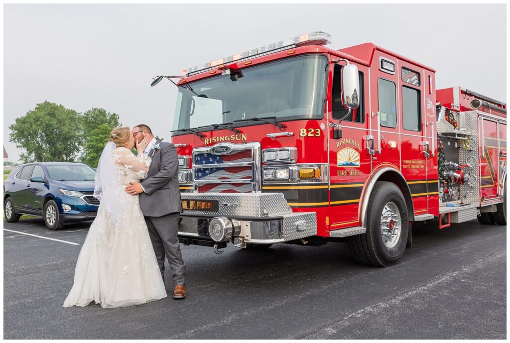 bride and groom kiss next to a Risingsun, Ohio red fire truck