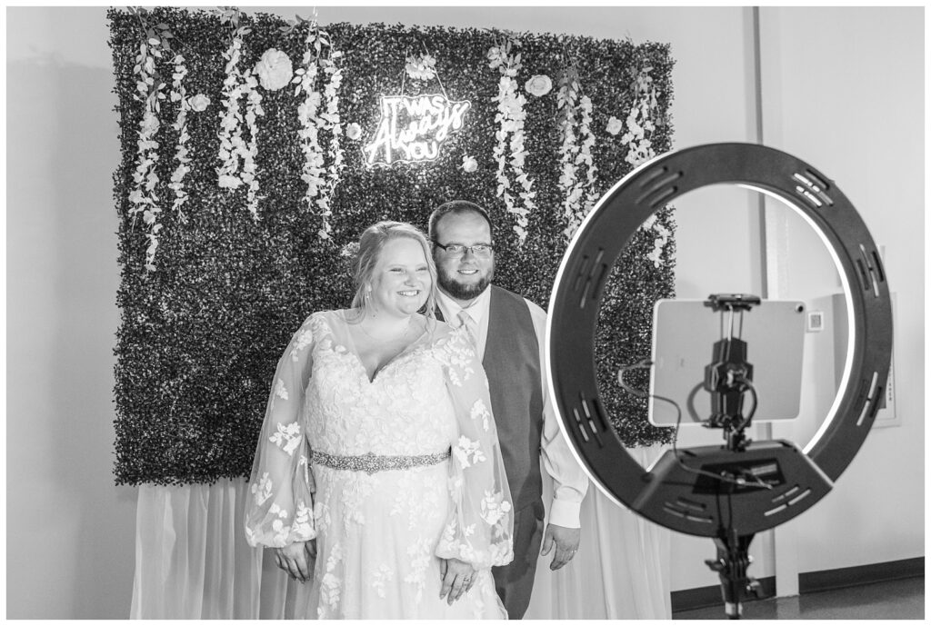 bride and groom posing at the photo book at summer wedding reception in Fostoria