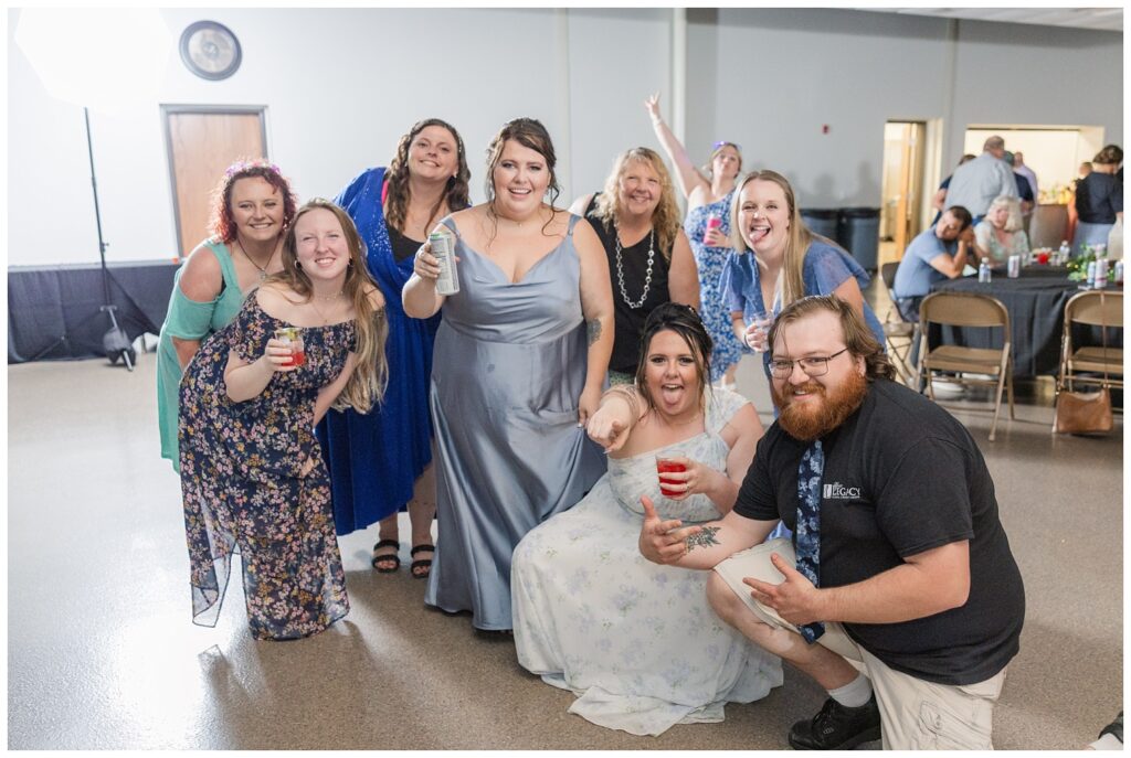 wedding guests posing with drinks and smiling at Fostoria, Ohio reception venue