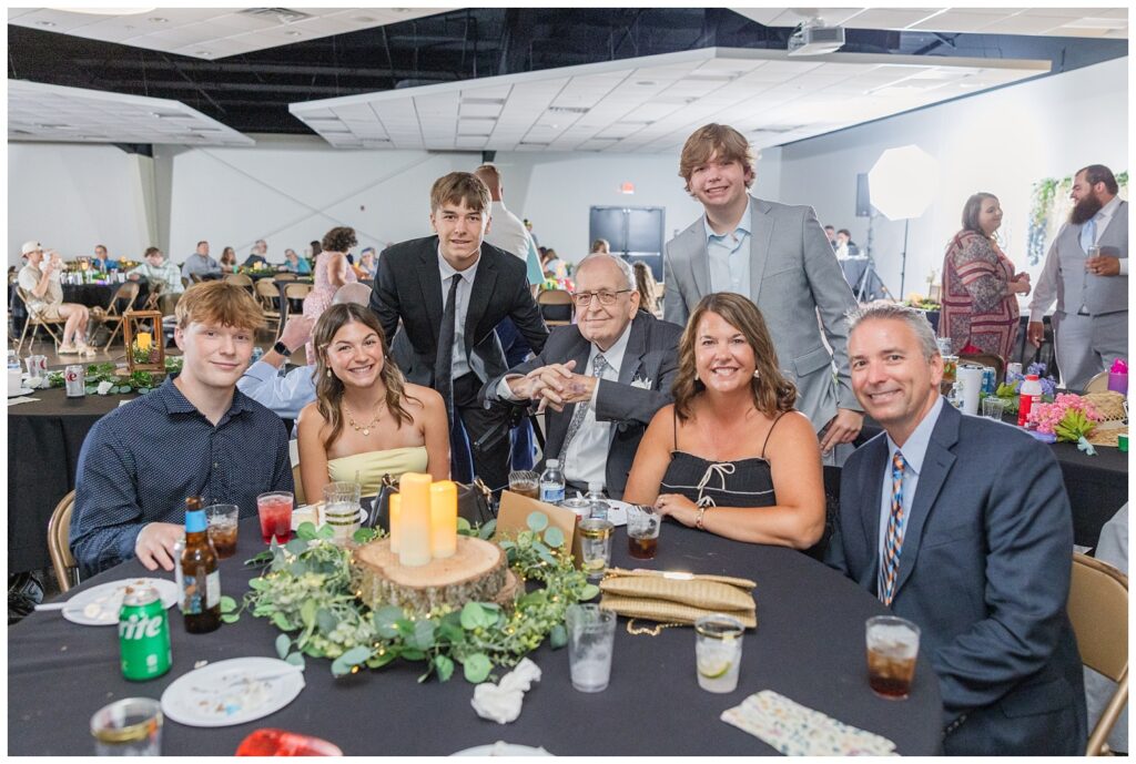 wedding guests smiling at their table at Stacy's Place wedding venue