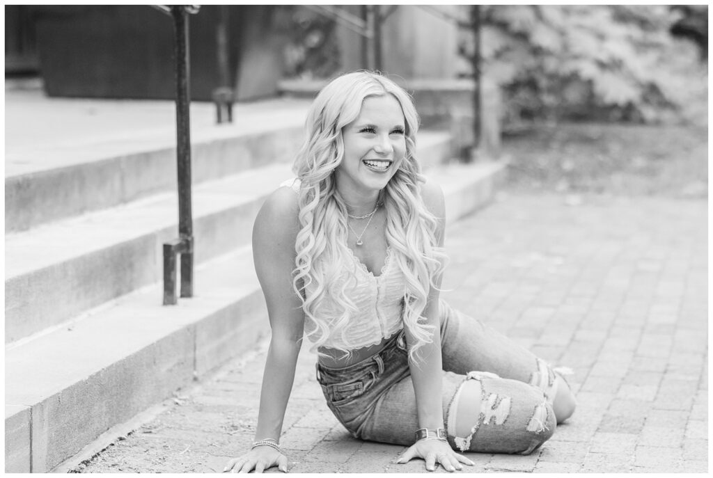 girl posing on the ground at stairs at Ohio State campus