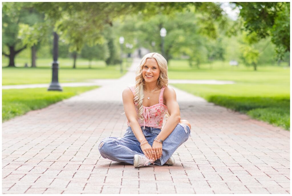 senior girl sitting on the Oval sidewalk at Ohio State in Columbus