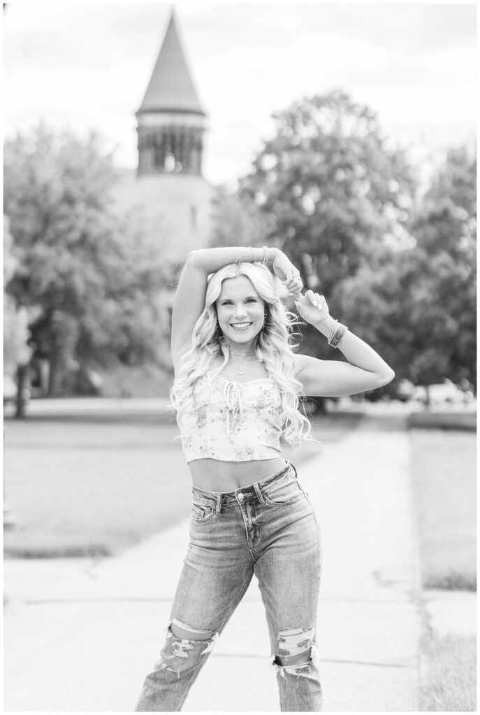 senior wearing a crop top and jeans with her arm over her head in Columbus, Ohio