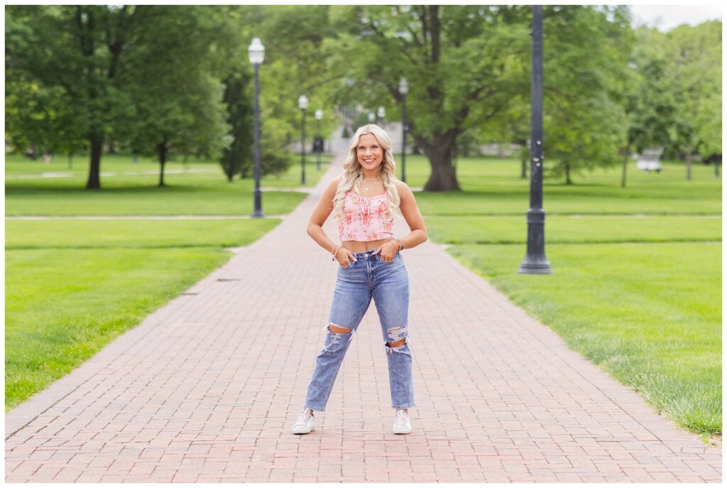 senior girl posing with her hands in her jean pockets and smiling at Columbus, Ohio session