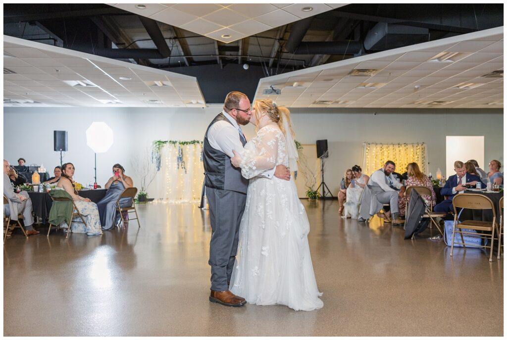 bride kissing the groom after their first dance at Stacy's Place venue