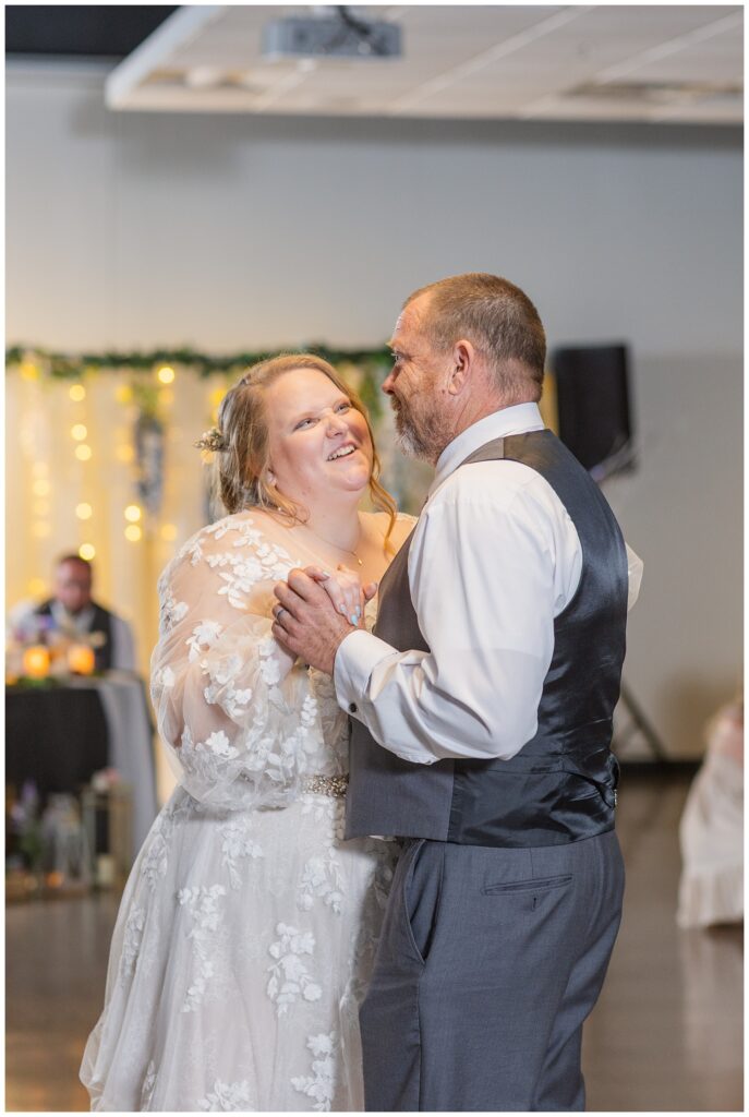 bride laughing with her dad while dancing during Ohio wedding reception