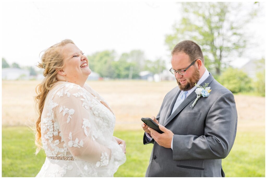 bride laughing with the groom after hearing his vows during first look