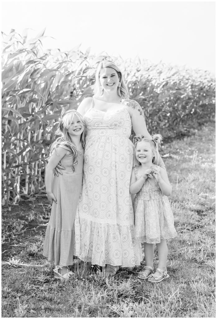 mom hugging her two girls near a corn field at Fremont, Ohio family session