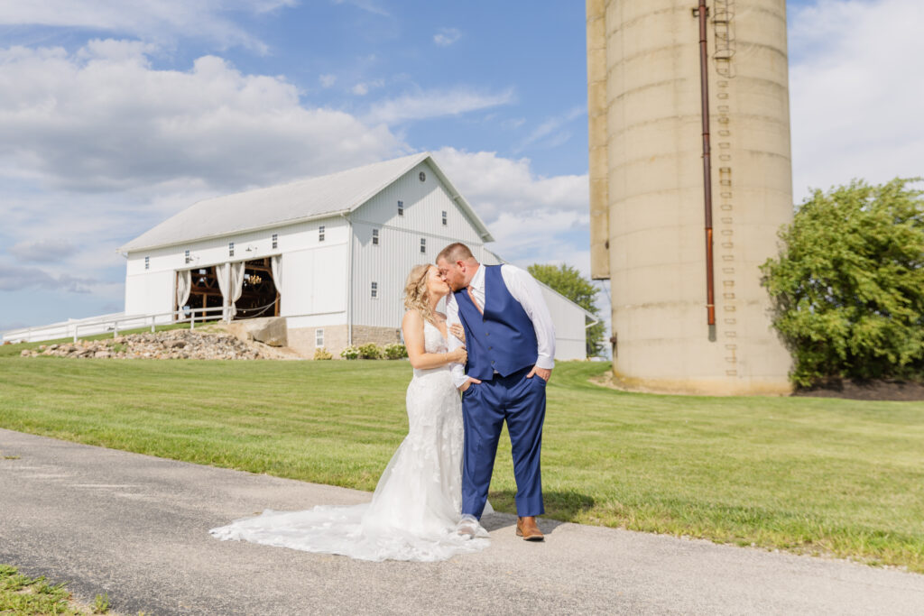 wedding couple kissing while posing on the path at Arlington Acres in Ohio