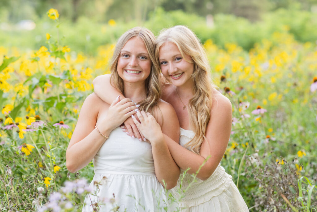 best friends hugging each other standing among wildflowers in Fremont, Ohio