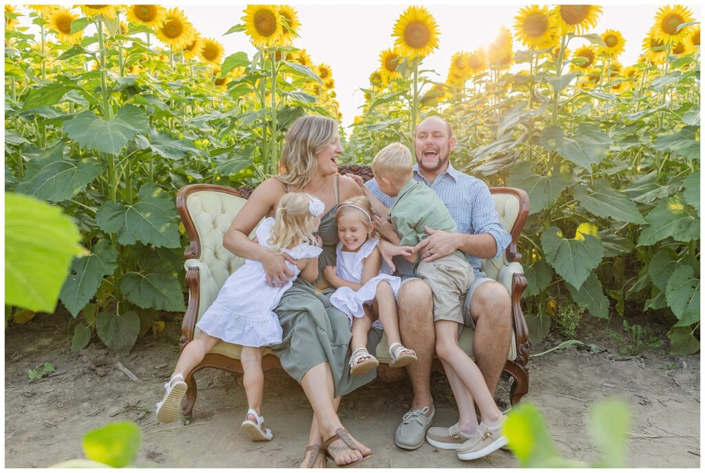 family sitting on a couch at a sunflower farm in Lindsey, Ohio