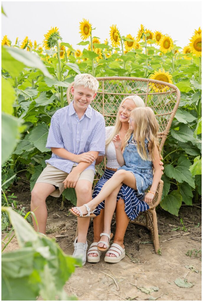 mom sitting with her kids at a sunflower farm in Lindsey, Ohio