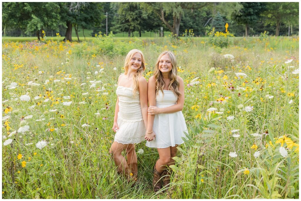 high school senior girls holding hands in a field in Fremont, Ohio