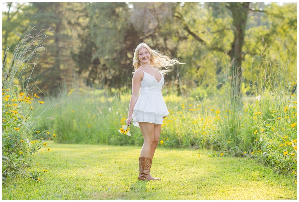 girl twirling and holding a bouquet of yellow and white flowers at Don Miller Park