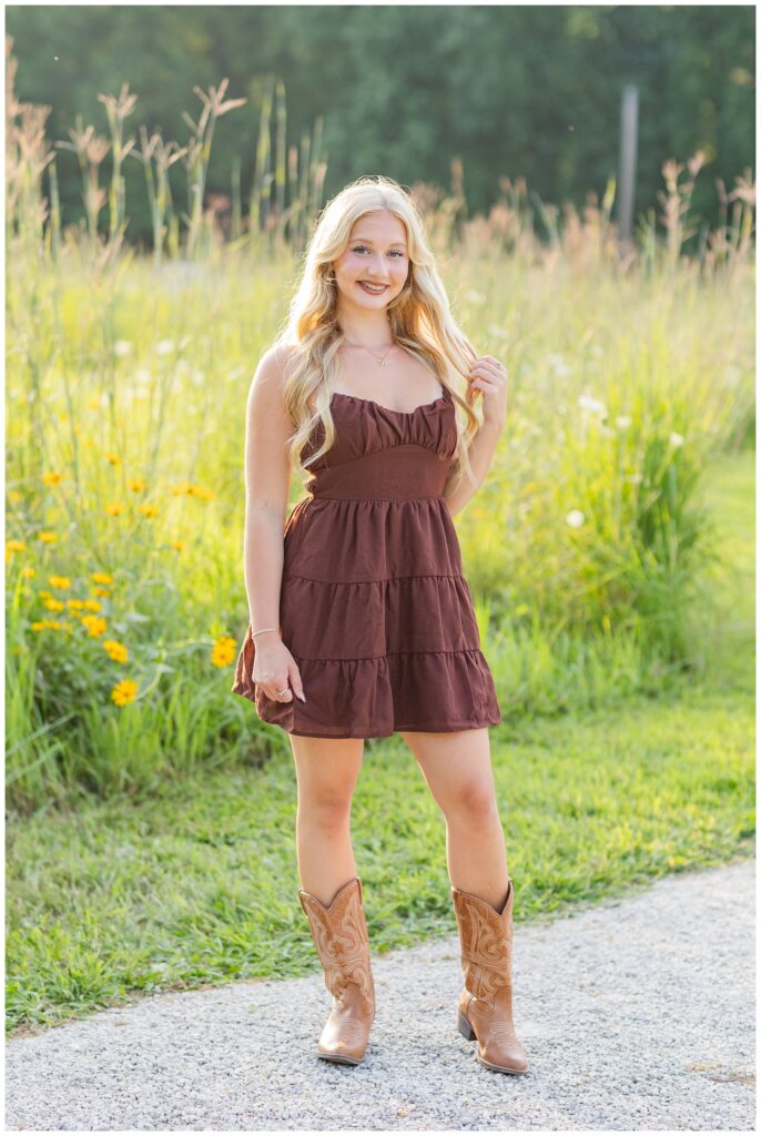 girl wearing a brown dress holding her hair and posing at Don Miller Park in Ohio